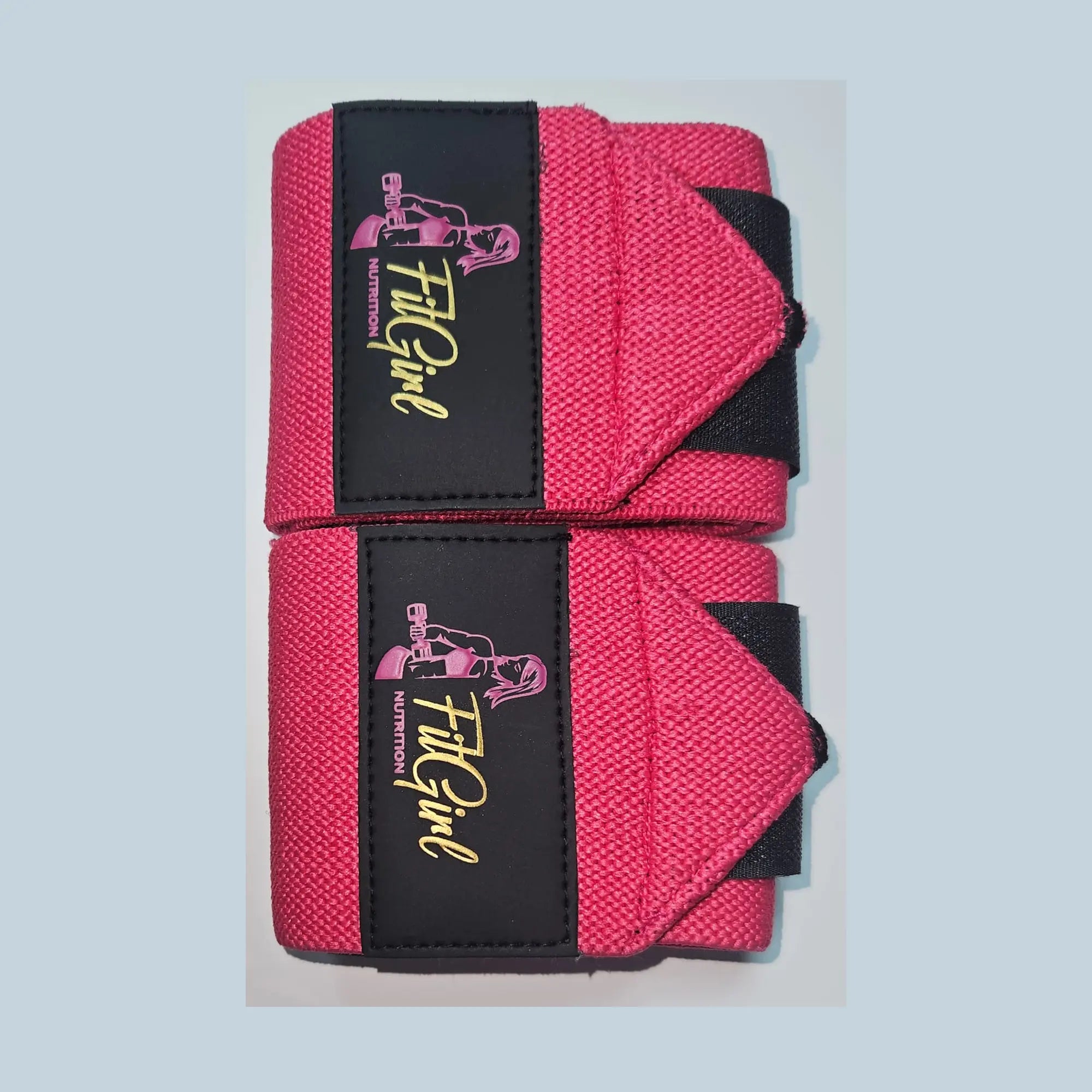 FitGirl Nutrition wrist wraps in neon pink voor polsondersteuning tijdens fitness en krachttraining
