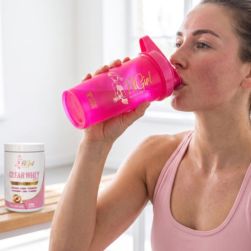 Woman drinking from the neon pink FitGirl shaker